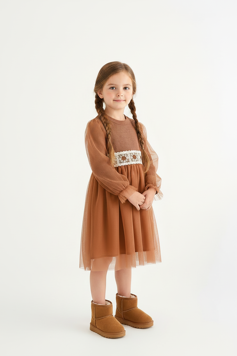 Girl with brown braids wearing brown dress and tan snow boots
