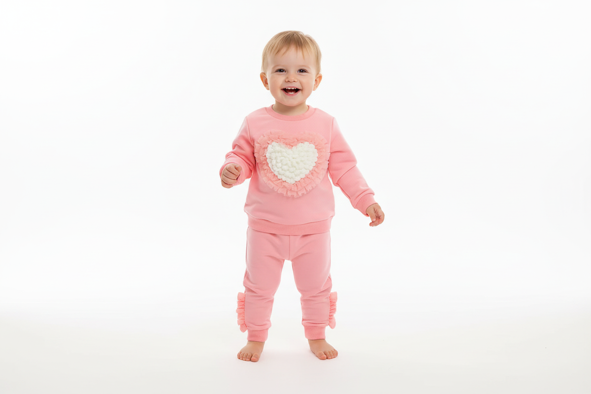 Toddler wearing pink heart sweatsuit